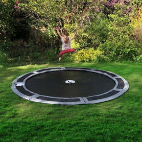 Grey round in-ground trampoline