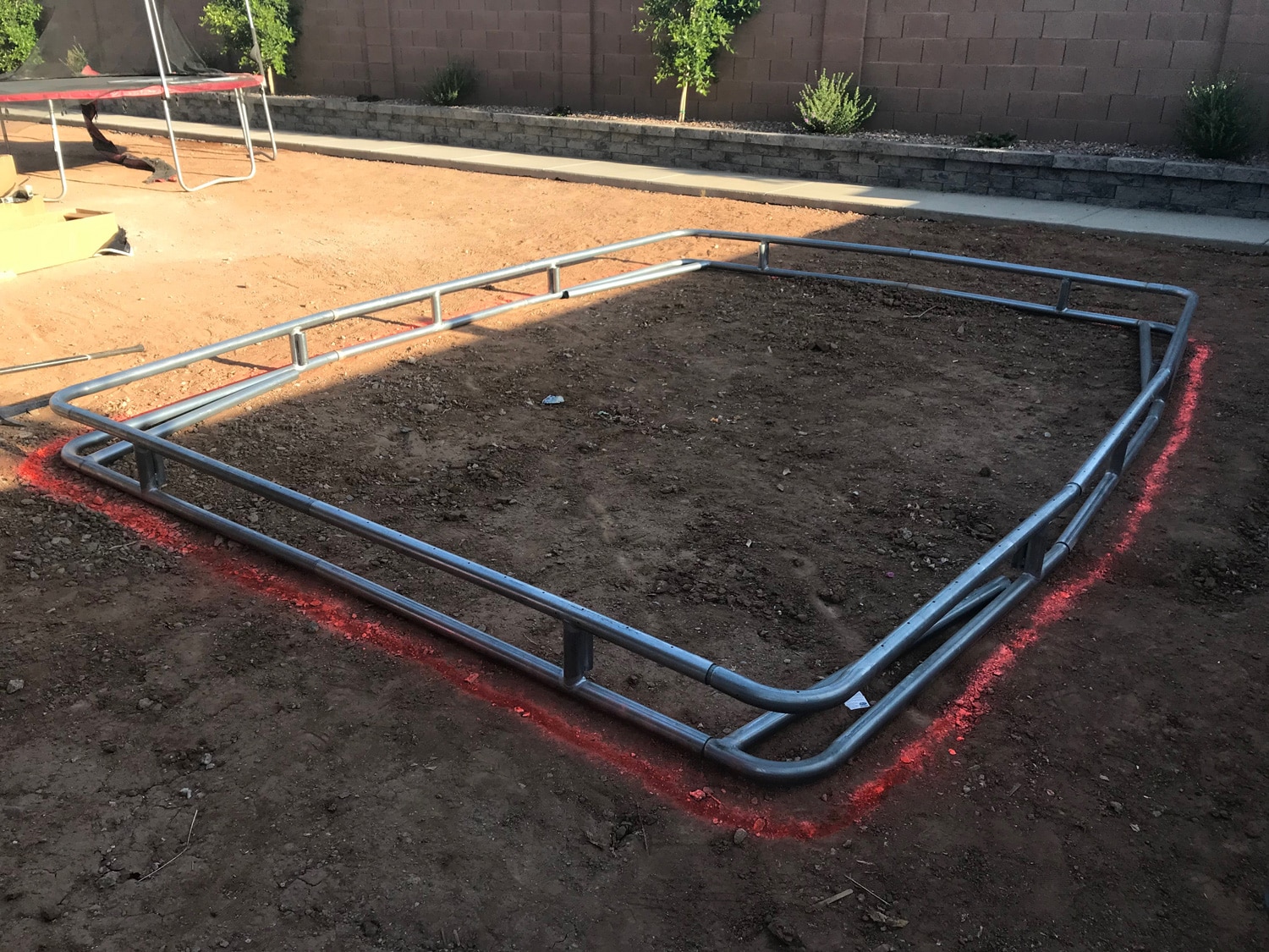 Patio steel frame marking for in-ground trampoline installation