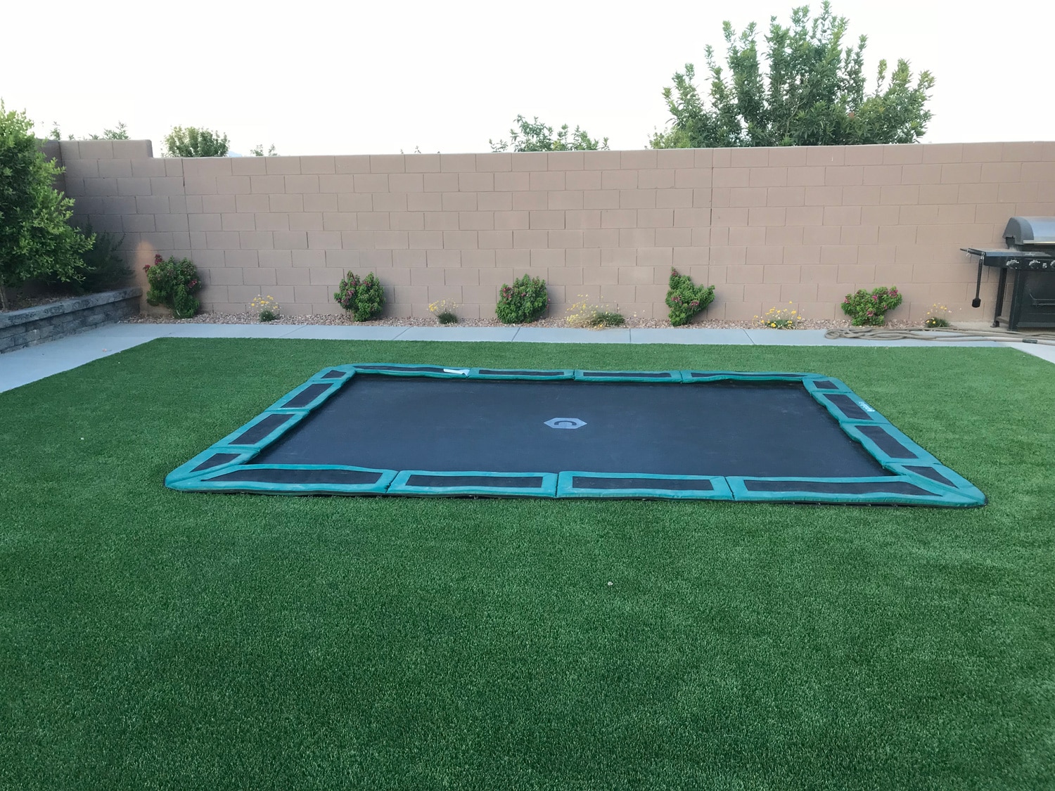 Rectangular in-ground trampoline in Arizona backyard