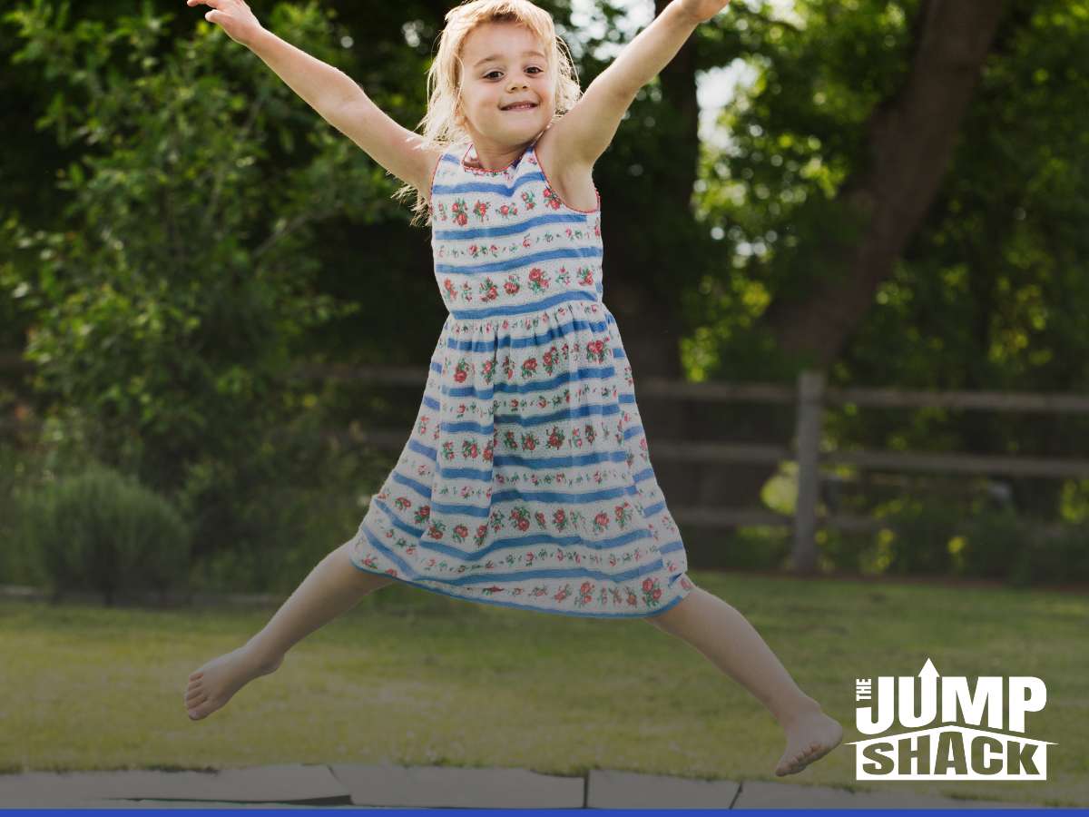 Child joyfully jumping on an in-ground trampoline installed by The Jump Shack.
