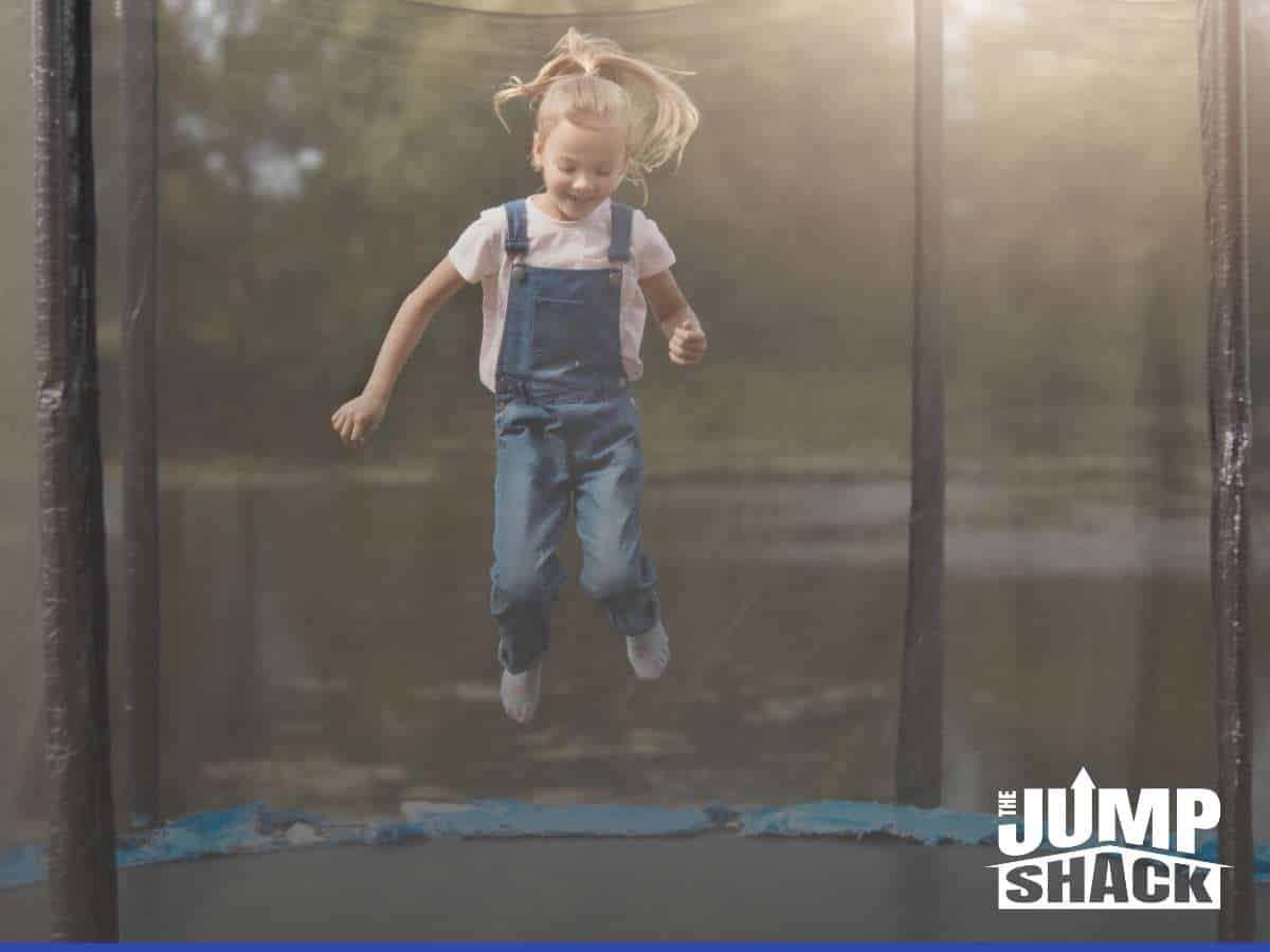 Joyful child jumping on a trampoline equipped with Trampoline Skirts by The Jump Shack for added safety