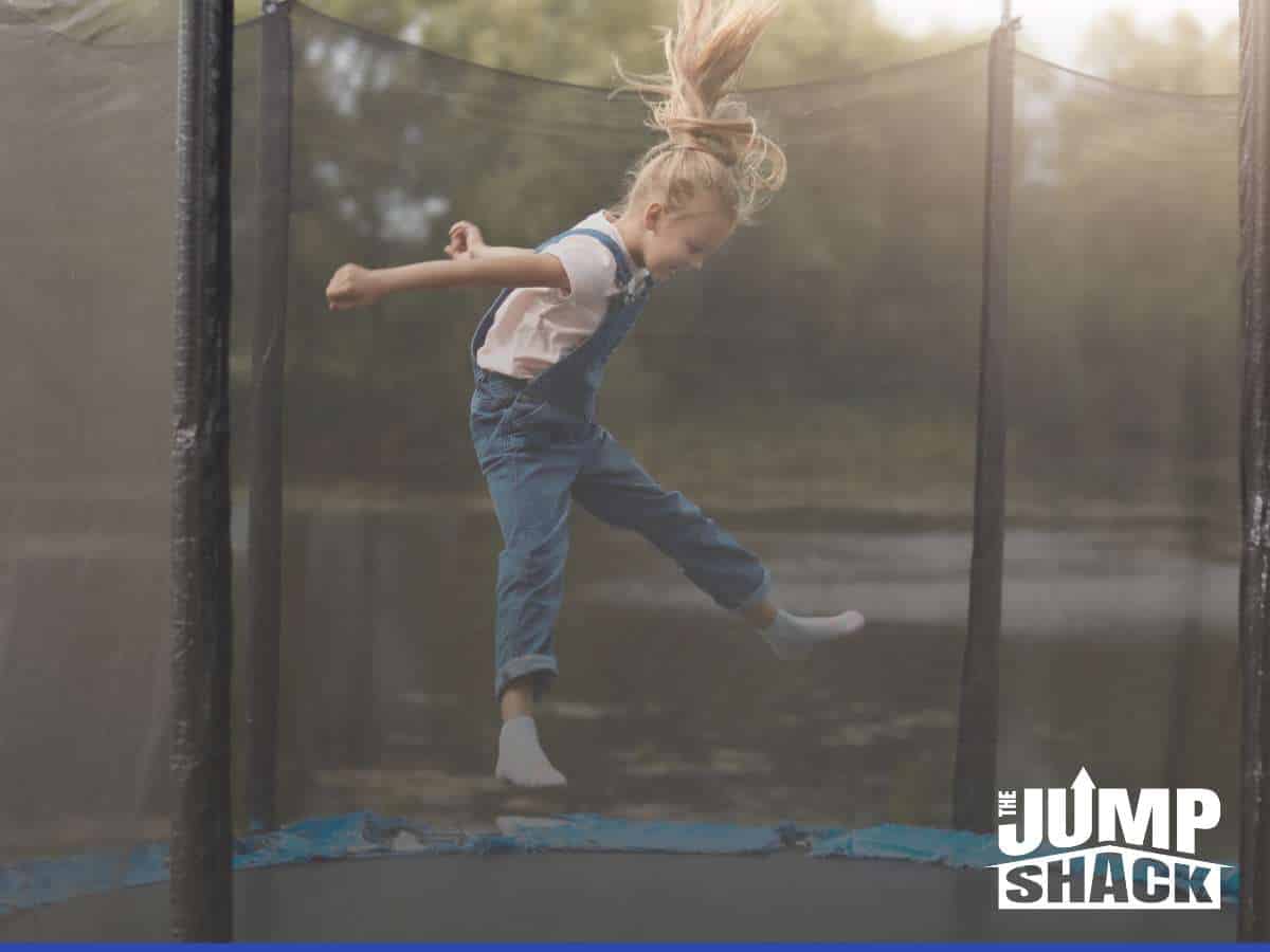 Child bouncing on an in-ground trampoline with secure Edge Padding in place, ensuring safe and fun outdoor playtime