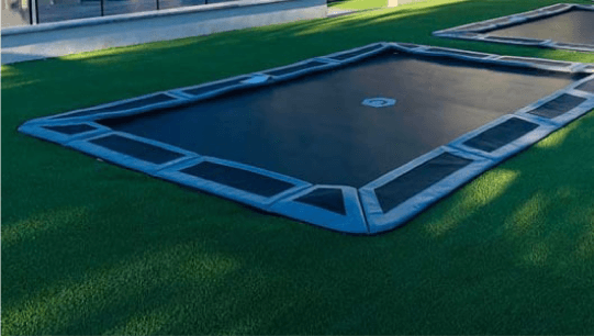 Custom in-ground trampoline installation in a Colorado backyard