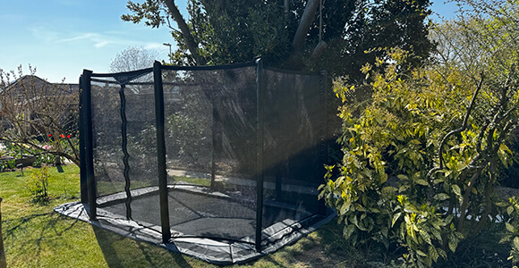 Green in-ground trampoline vented safety pads for superior airflow
